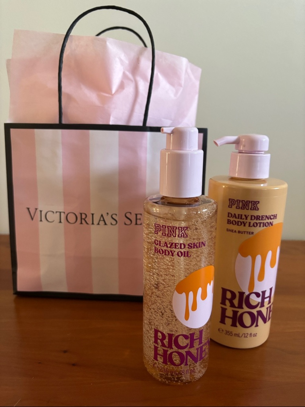 Pink Victoria’s Secret rich honey, glazed skin body oil, and daily drench lotion